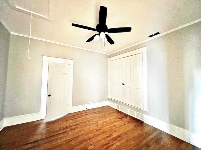 unfurnished bedroom with ceiling fan, wood-type flooring, and crown molding