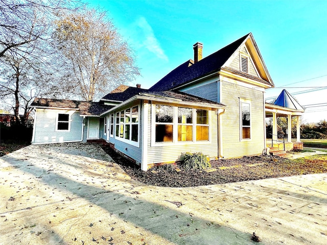 view of property exterior featuring a sunroom