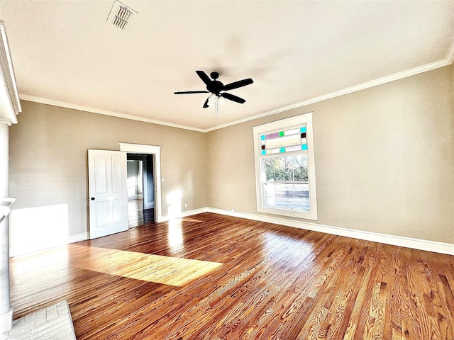 empty room featuring ceiling fan, ornamental molding, and hardwood / wood-style floors