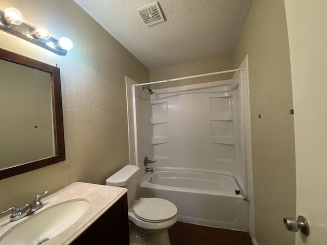 full bathroom featuring vanity,  shower combination, a textured ceiling, and toilet