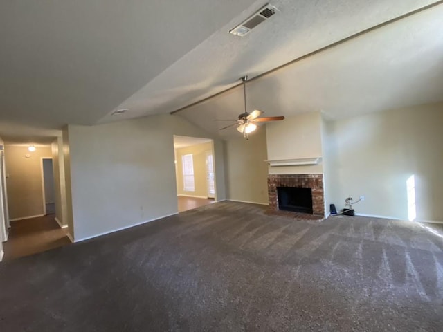 unfurnished living room with carpet floors, vaulted ceiling with beams, a fireplace, and ceiling fan