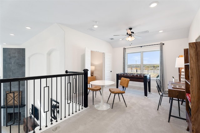 interior space featuring lofted ceiling, carpet floors, and ceiling fan