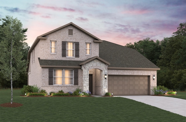 view of front of home with a garage and a lawn