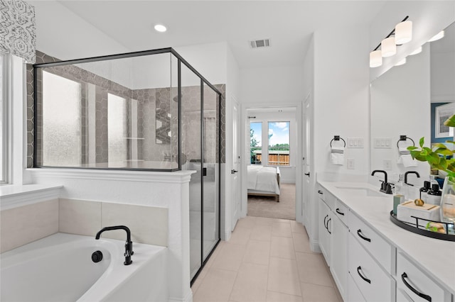 bathroom with independent shower and bath, vanity, and tile patterned flooring