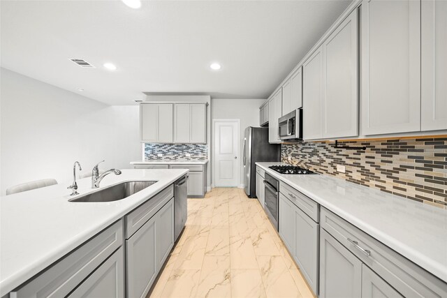 6225 Kent Ln, Celina, TX 76227 - kitchen with a sink, light marble finish flooring, appliances with stainless steel finishes, recessed lighting, and light countertops