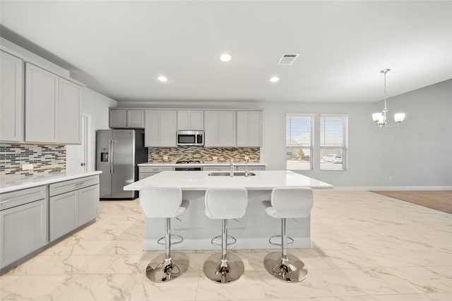 6225 Kent Ln, Celina, TX 76227 - kitchen featuring stainless steel appliances, a sink, light marble finish flooring, light countertops, and decorative backsplash