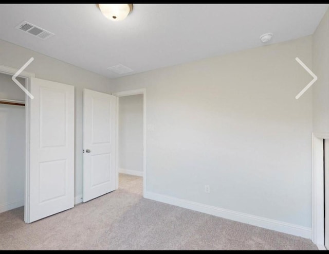 unfurnished bedroom featuring light colored carpet