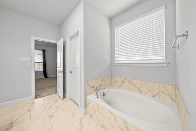 6225 Kent Ln, Celina, TX 76227 - full bath featuring marble look tile flooring, a bath, and baseboards