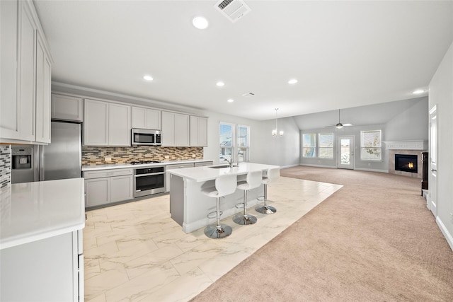 6225 Kent Ln, Celina, TX 76227 - kitchen featuring stainless steel appliances, recessed lighting, open floor plan, a breakfast bar area, and light countertops