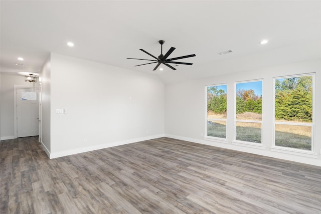 unfurnished room featuring ceiling fan, vaulted ceiling, and hardwood / wood-style flooring