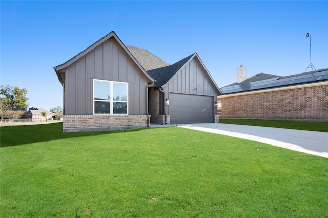 view of front of home with a garage and a front lawn