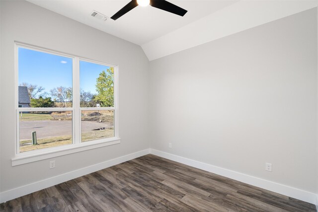 spare room with ceiling fan, dark wood-type flooring, and vaulted ceiling