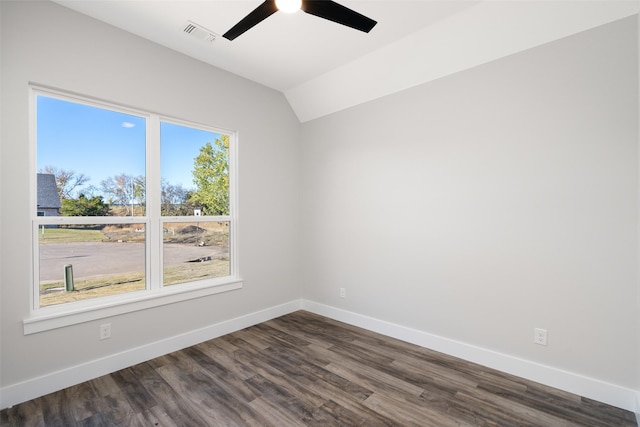 empty room with vaulted ceiling, dark wood-type flooring, and ceiling fan