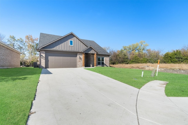 view of front of property with central AC unit, a garage, and a front lawn