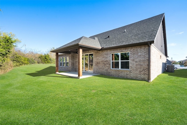 rear view of property featuring central AC, a patio, and a lawn