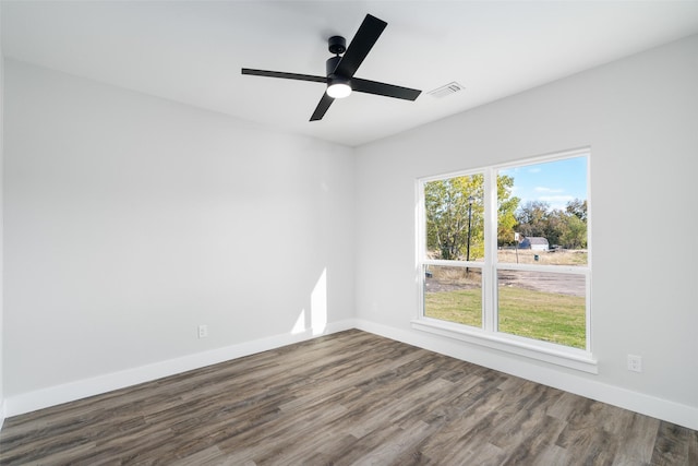 spare room featuring dark wood-type flooring and ceiling fan