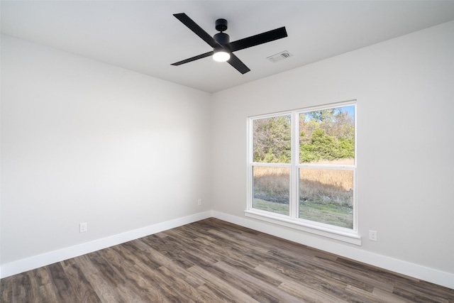 spare room with hardwood / wood-style floors and ceiling fan