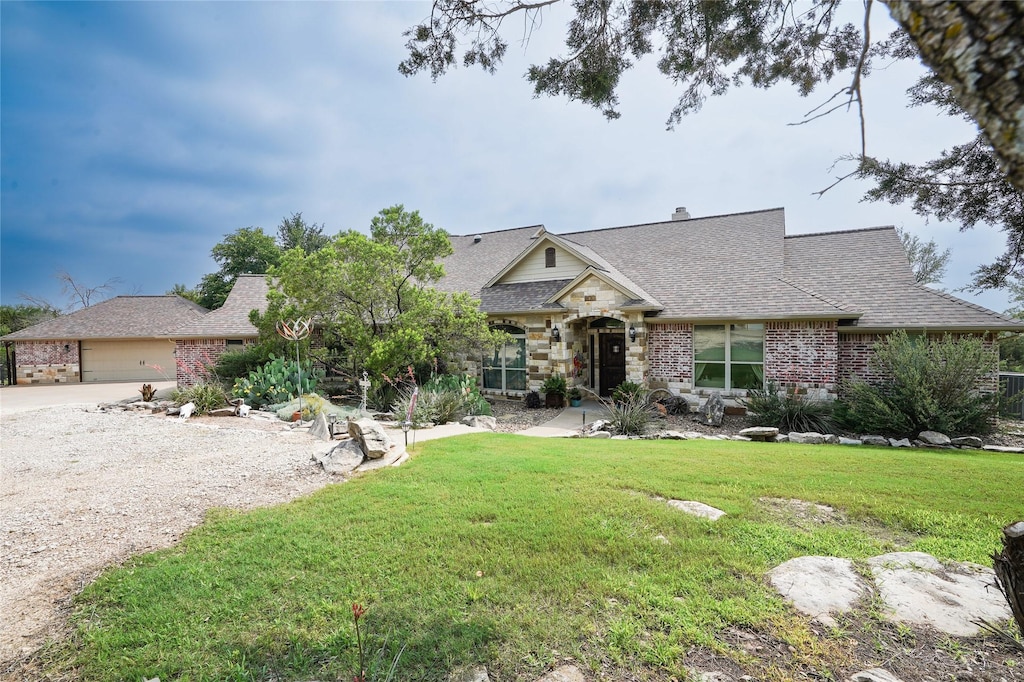 view of front of home featuring a garage and a front lawn