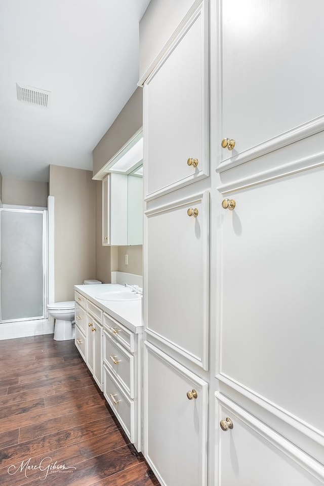 bathroom featuring hardwood / wood-style floors, vanity, and toilet