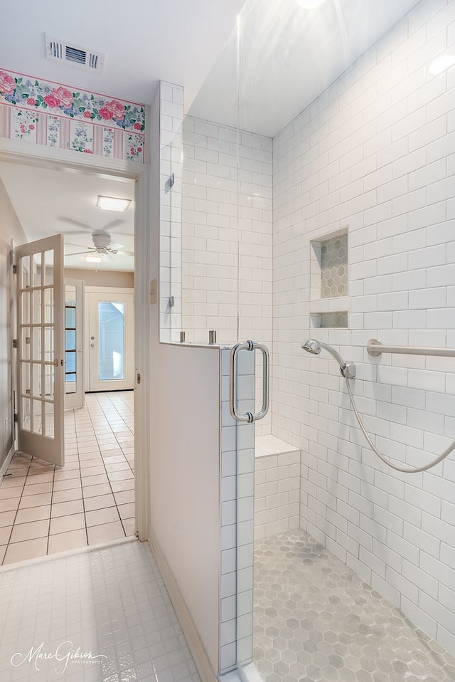 bathroom with ceiling fan, tile patterned flooring, and walk in shower