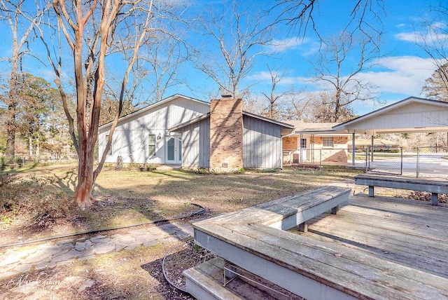 exterior space with a front lawn and a carport