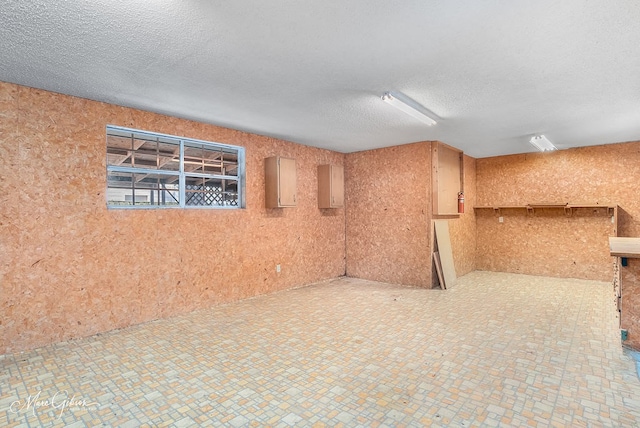 spare room featuring a textured ceiling and electric panel