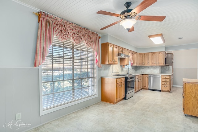 kitchen featuring appliances with stainless steel finishes, tasteful backsplash, ceiling fan, and a healthy amount of sunlight