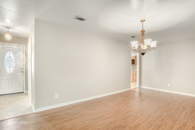 interior space featuring a chandelier and light wood-type flooring