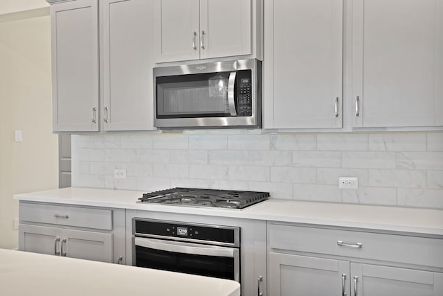 kitchen with appliances with stainless steel finishes and tasteful backsplash