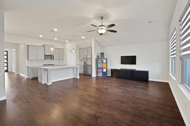 unfurnished living room with ceiling fan, lofted ceiling, and a wealth of natural light