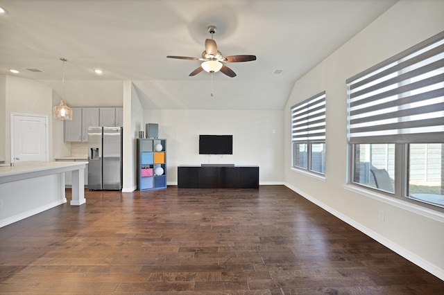 unfurnished living room featuring dark hardwood / wood-style floors, ceiling fan, and lofted ceiling