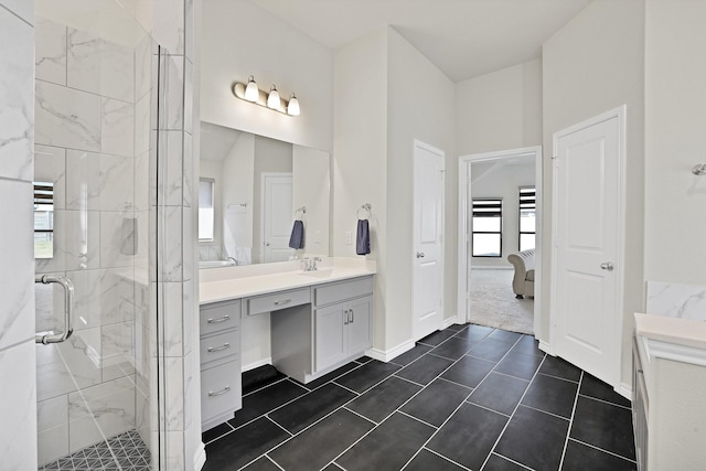 bathroom with tile patterned floors, vanity, and an enclosed shower