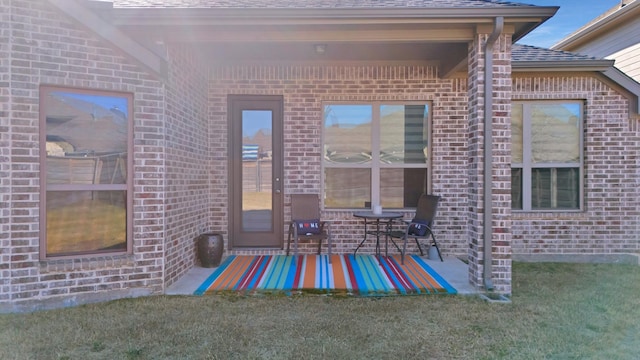 rear view of house featuring a yard and a patio