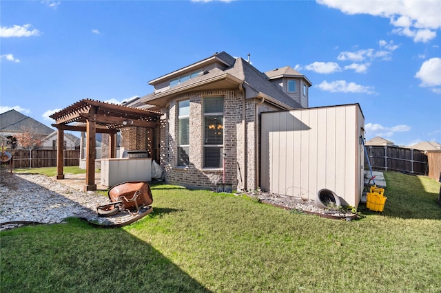 back of house featuring a pergola and a yard