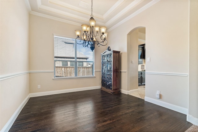 unfurnished dining area featuring a tray ceiling, crown molding, and dark hardwood / wood-style flooring