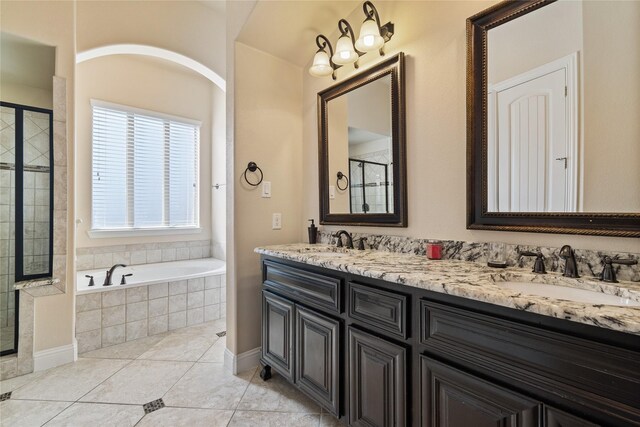 bathroom featuring tile patterned flooring, vanity, and shower with separate bathtub