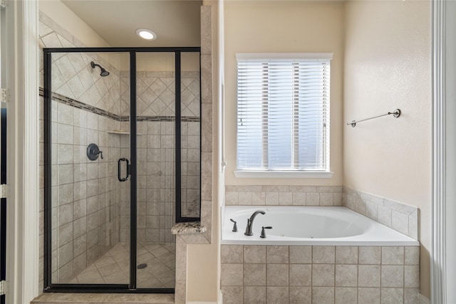 bathroom featuring a wealth of natural light and plus walk in shower