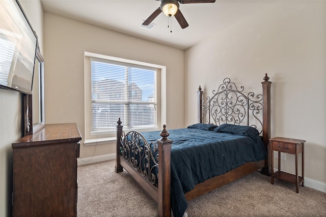 bedroom featuring multiple windows, ceiling fan, and light carpet