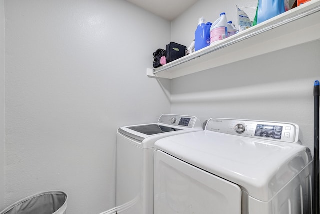 clothes washing area featuring independent washer and dryer