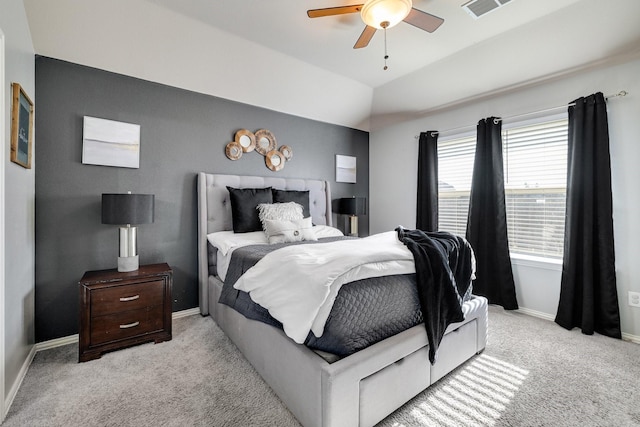 bedroom with light colored carpet, vaulted ceiling, and ceiling fan