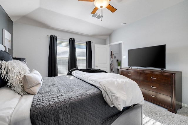 carpeted bedroom with ceiling fan and vaulted ceiling