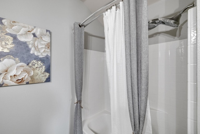 bathroom with shower / bath combo with shower curtain