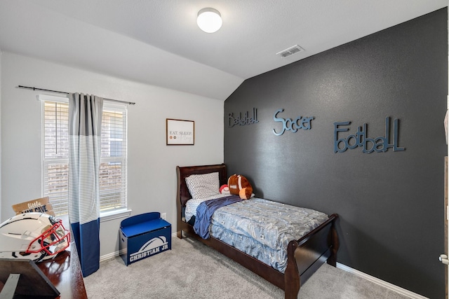 bedroom featuring light colored carpet and lofted ceiling