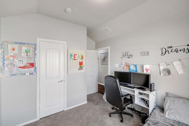 carpeted office space featuring vaulted ceiling