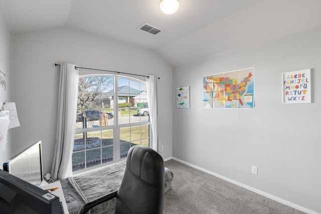 carpeted office featuring vaulted ceiling