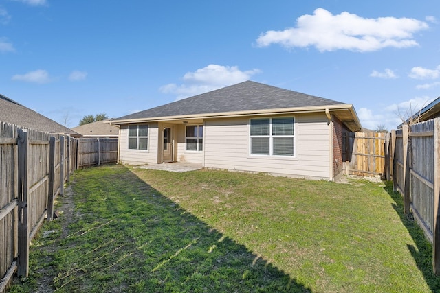 rear view of house featuring a lawn