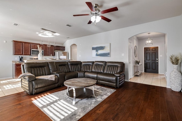 living room with light hardwood / wood-style floors and ceiling fan