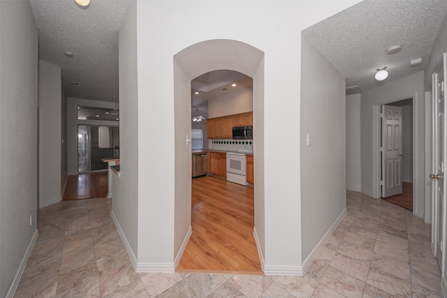 hall with a textured ceiling