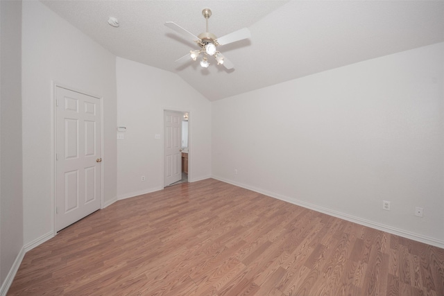 unfurnished room featuring ceiling fan, light hardwood / wood-style flooring, and lofted ceiling