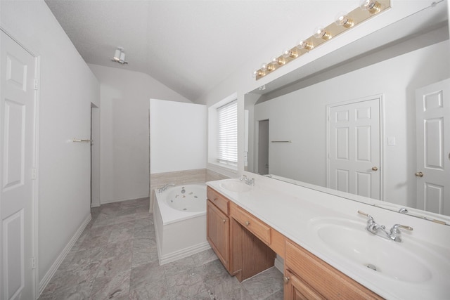 bathroom with a textured ceiling, a tub, vanity, and lofted ceiling